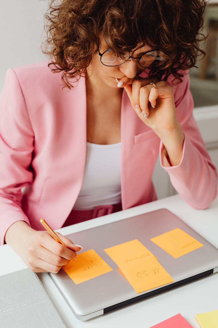 woman writing on sticky notes